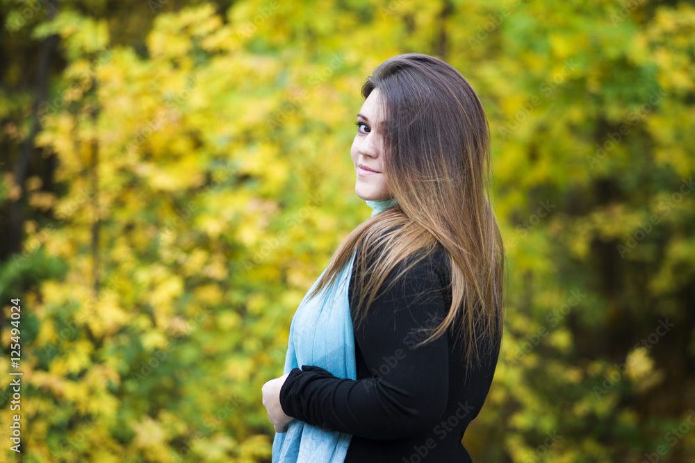 Young beautiful caucasian plus size model in black dress outdoors, xxl woman on nature, autumn atmosphere Young beautiful caucasian plus size model in black dress outdoors, xxl woman on nature, autumn atmosphere