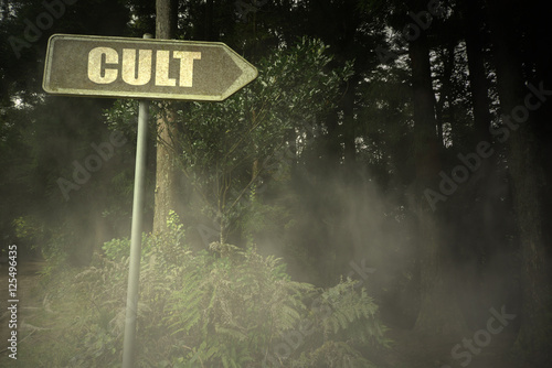 old signboard with text cult near the sinister forest photo