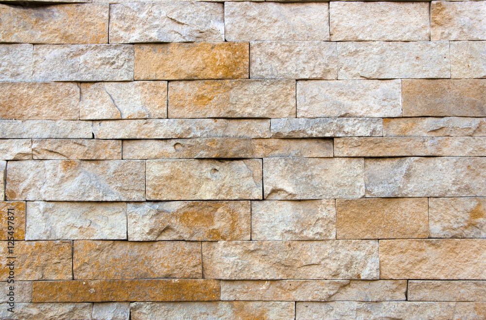Fototapeta premium house wall decorated with multi-colored sandstone wall tiles