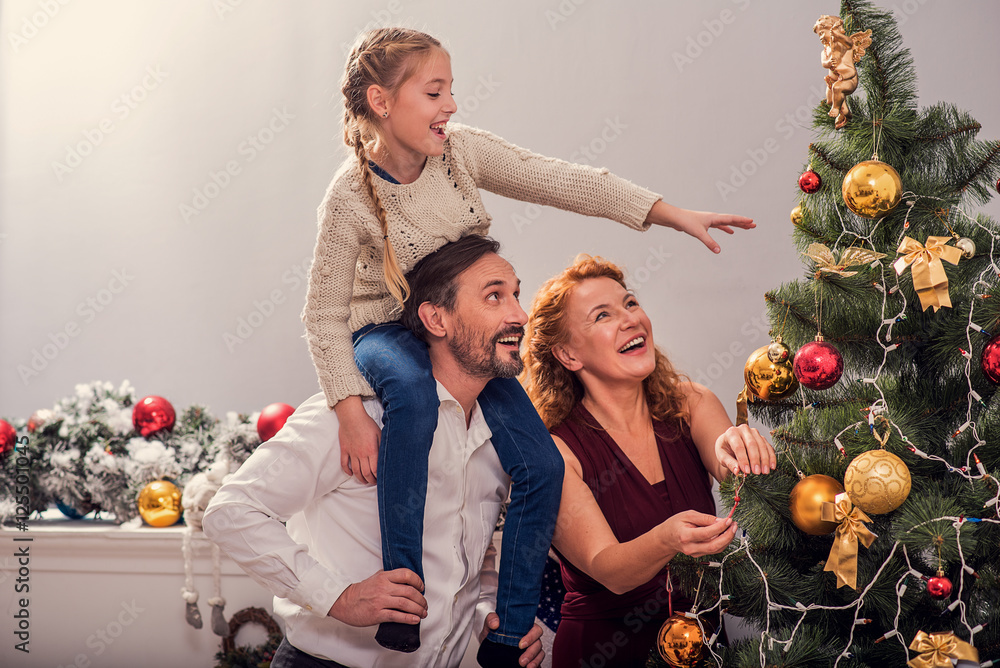Fototapeta premium I like decorating fir-tree with my parents