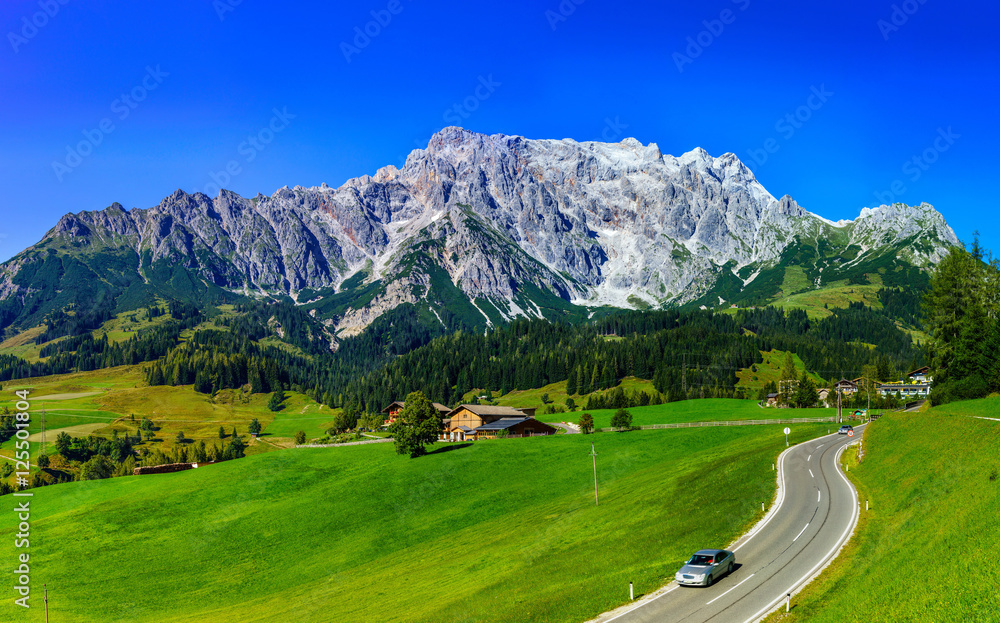 Beautiful alpine summer landscape. Mountains and sun, blue sky,