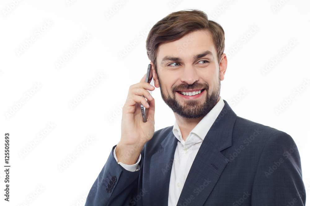 Handsome business man talking on the phone and smiling, isolated Handsome business man talking on the phone and smiling, isolated