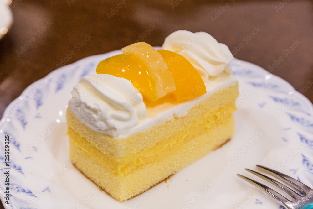 Delicious cheese cake with peach on top.