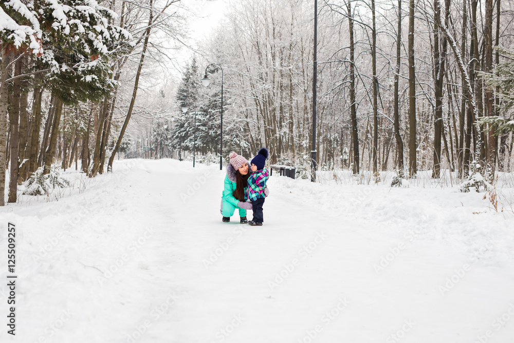 Little girl and her mom having fun on a winter day Little girl and her mom having fun on a winter day