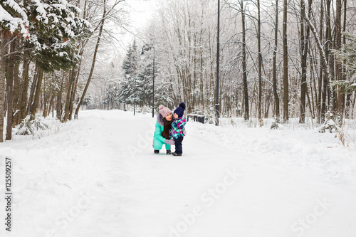 Little girl and her mom having fun on a winter day