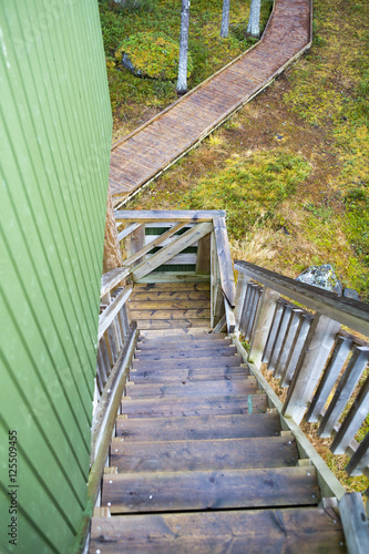 Fototapeta Naklejka Na Ścianę i Meble -  Wet wooden stairs going down.