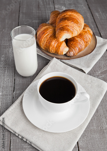 Fototapeta Naklejka Na Ścianę i Meble -  Cup of black coffee and croissant and milk