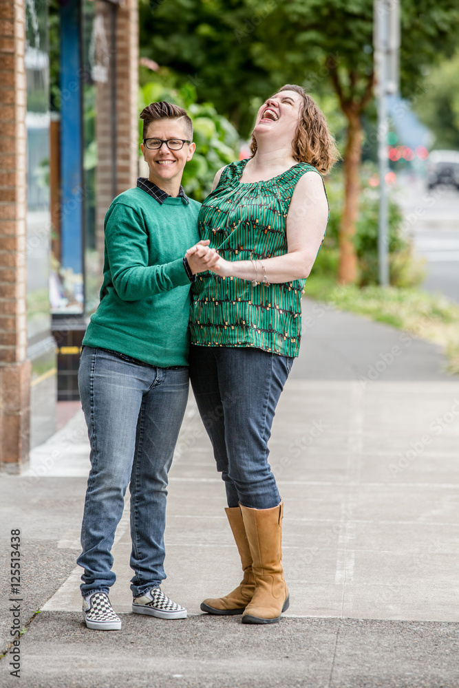 Laughing couple standing outdoors