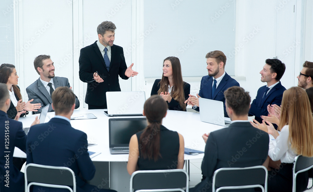 Business group greets leader with clapping and smiling Business group greets leader with clapping and smiling