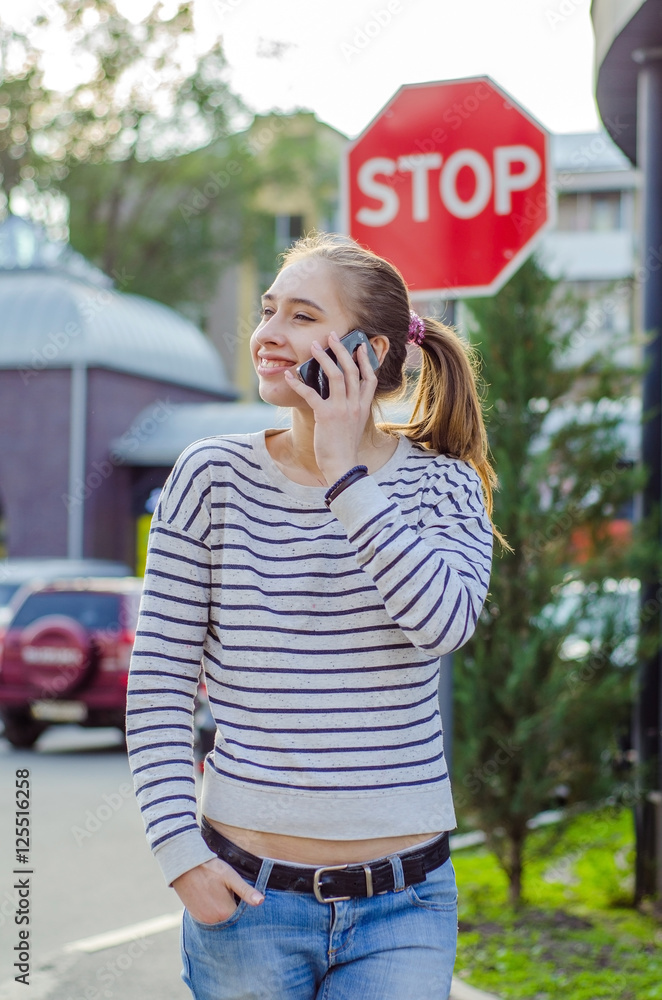 Fototapeta premium Young woman using her phone