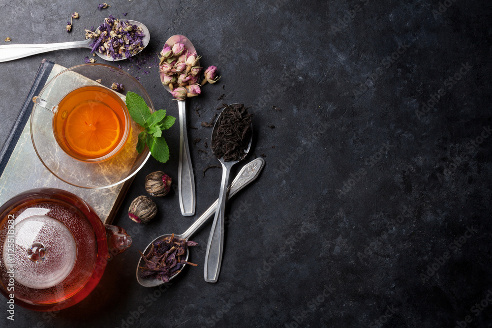 Tea cup and assortment of dry tea in spoons Tea cup and assortment of dry tea in spoons