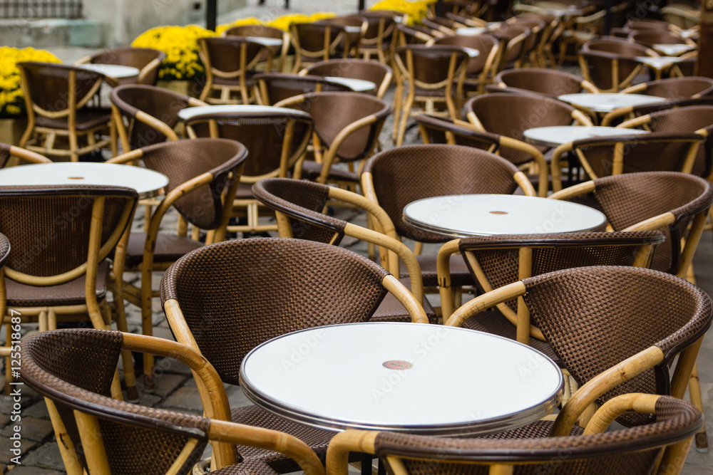 Empty tables of outdoor cafe in city center of Lviv, Ukraine in Europe Empty tables of outdoor cafe in city center of Lviv, Ukraine in Europe