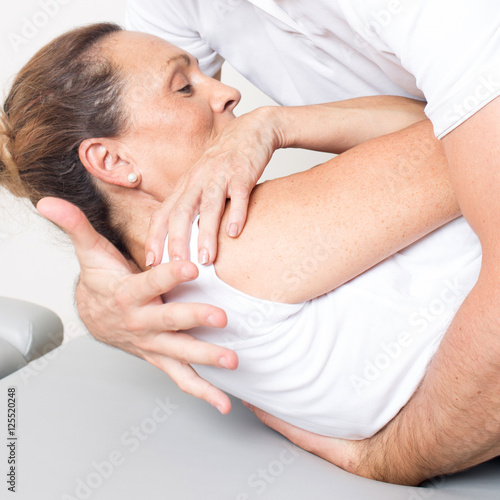 Doctor applying a body manipulation on a senior female patient