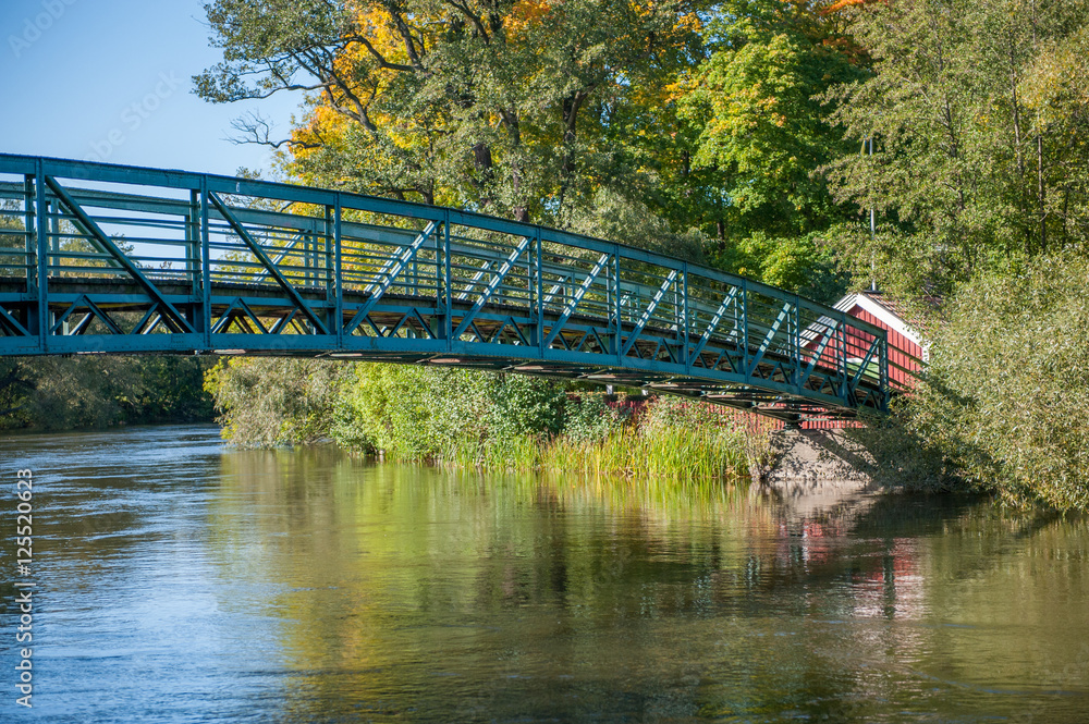 Fototapeta premium Historic five-penny bridge across Motala stream in Norrkoping during autumn in Sweden