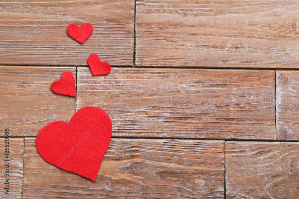 Love hearts on a brown wooden table Love hearts on a brown wooden table