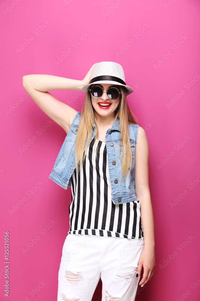 Portrait of a beautiful hipster girl on pink background Portrait of a beautiful hipster girl on pink background