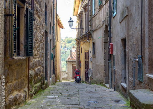 alley of the village with old fashioned scooter