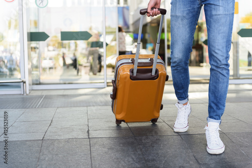 Male tourist walking with luggage