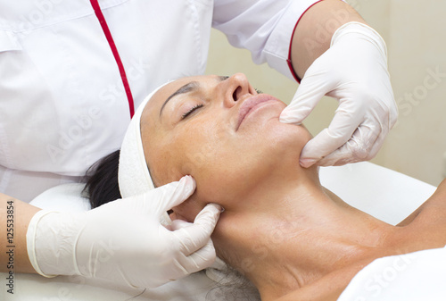 Process of massage and facials in beauty salon