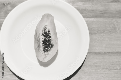 Sliced fruit fresh papaya on white plate. Top view flat lay style