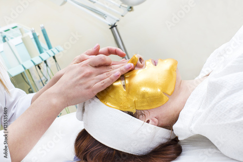 Process of massage and facials in beauty salon photo