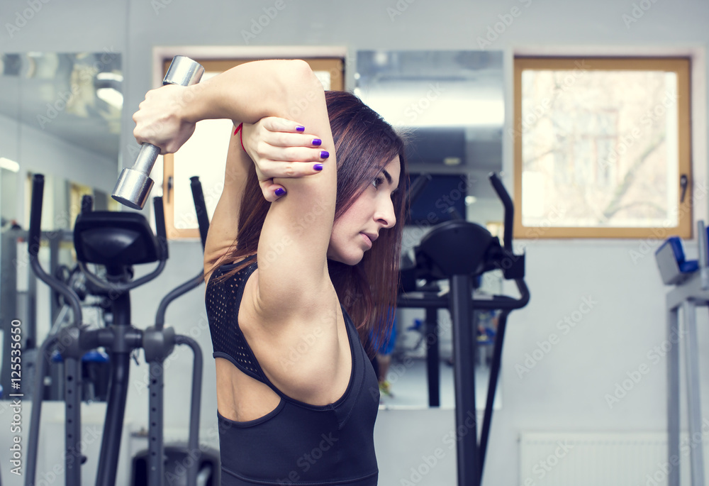 Girl is engaged in sports and gymnastics in the gym Girl is engaged in sports and gymnastics in the gym