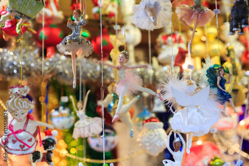 Colorful close up details of christmas fair market. Ballerina balls decorations for sales.