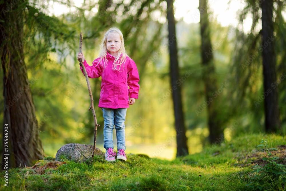Cute little girl having fun during forest hike on beautiful autumn day Cute little girl having fun during forest hike on beautiful autumn day