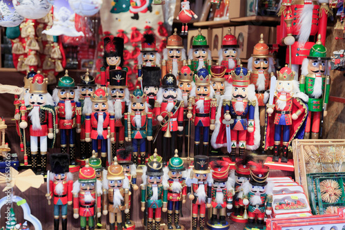 Colorful close up details of christmas fair market. Nutcracker figures decorations for sales.