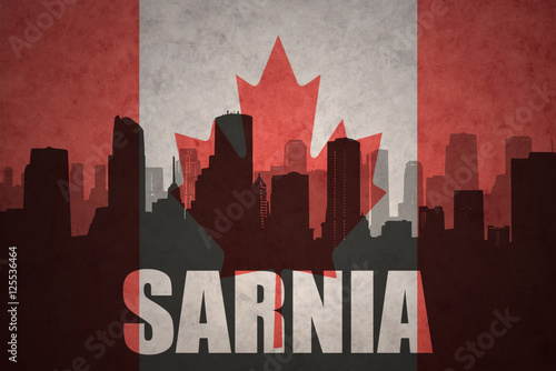 abstract silhouette of the city with text Sarnia at the vintage canadian flag photo