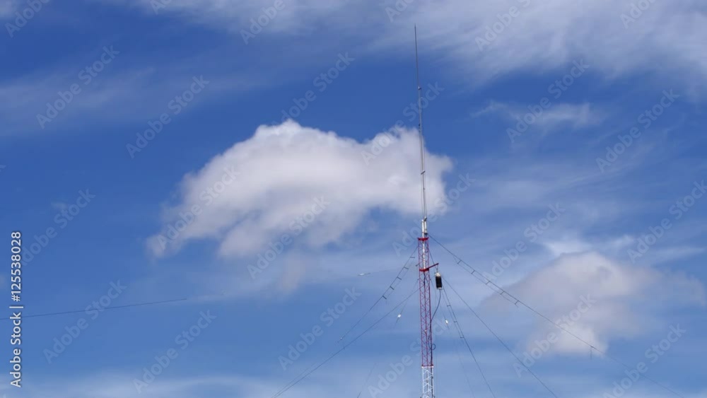 Home based single spike Telecommunications antenna tower light clouds day time lapse with no birds in it. Home based single spike Telecommunications antenna tower light clouds day time lapse with no birds in it.