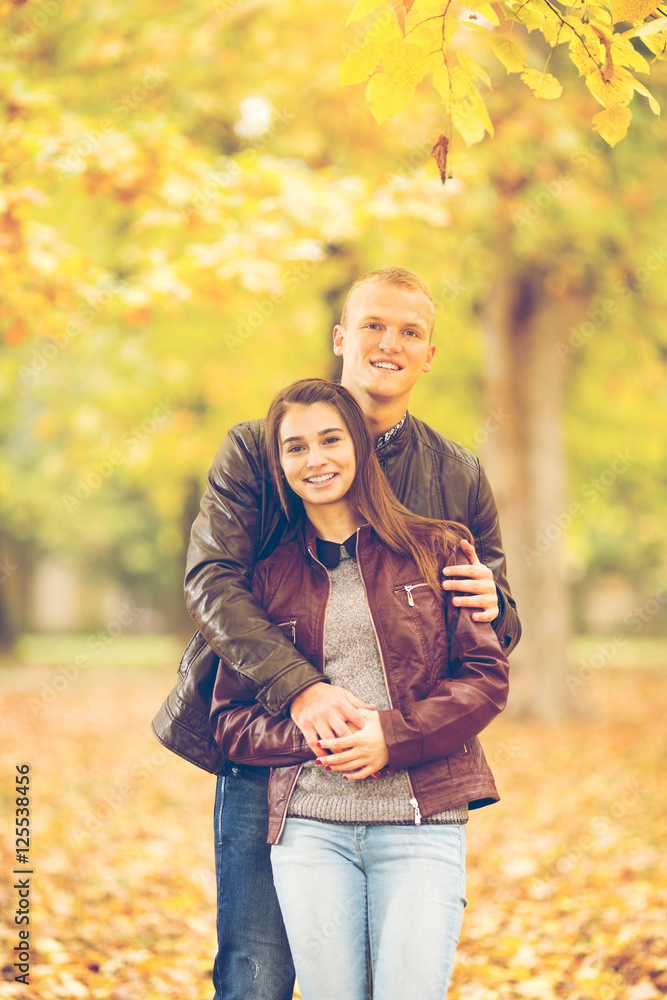 Young couple having fun in a park on one beautiful Autumn day. Young couple having fun in a park on one beautiful Autumn day.
