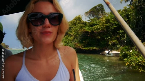 Young girl in a sunglasses travel by boat through Kalu Ganga river