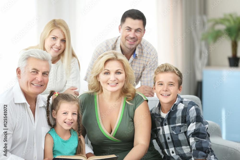 Happy family reading book at home Happy family reading book at home