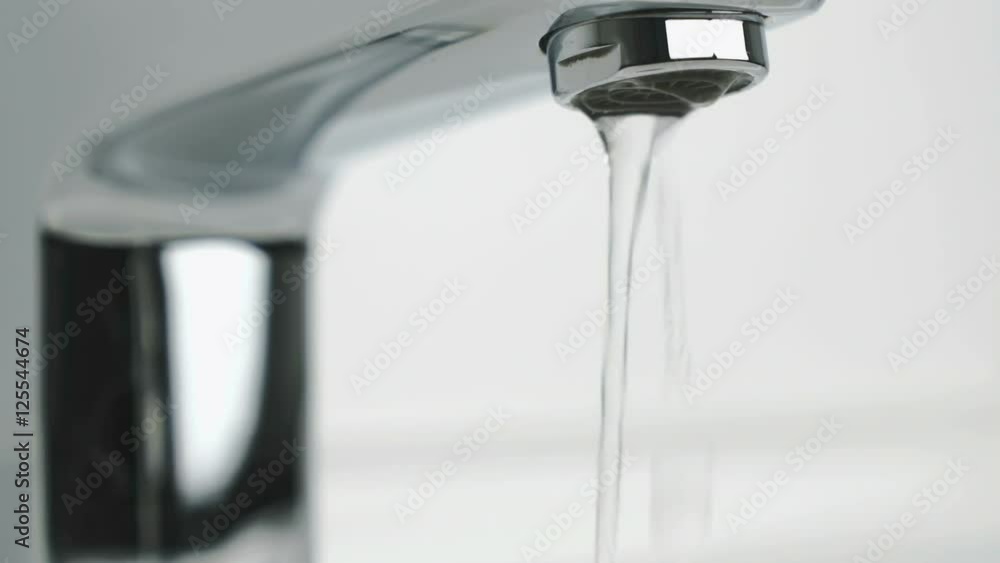Weak stream of water pouring from the chrome tap Weak stream of water pouring from the chrome tap