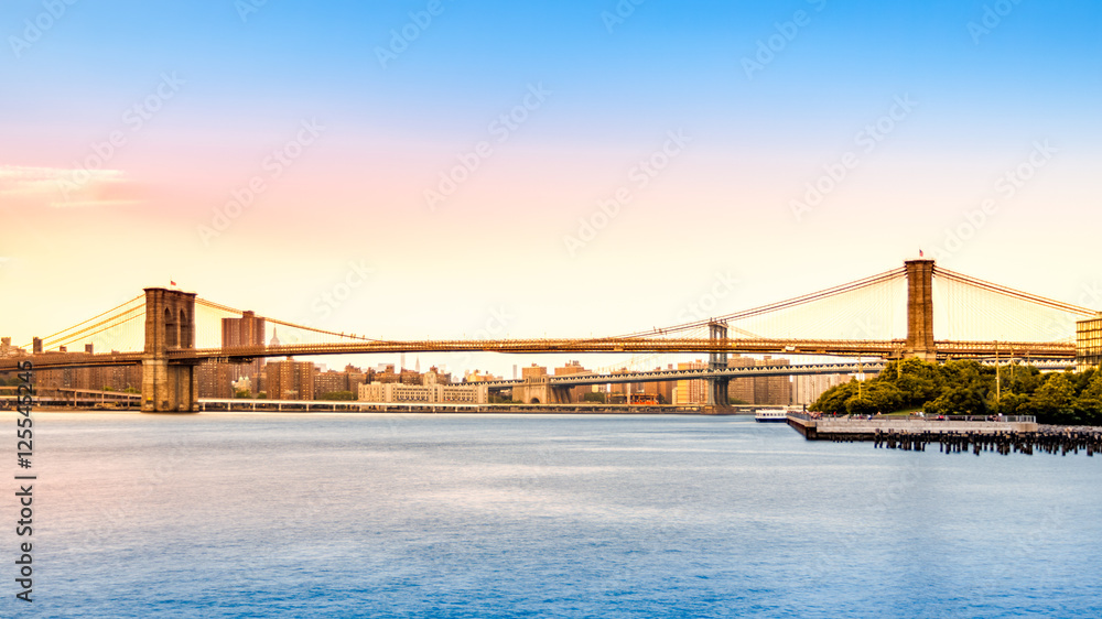 Brooklyn Bridge and Manhattan skyline at sunset viewed from Pier2 park in New Yok City