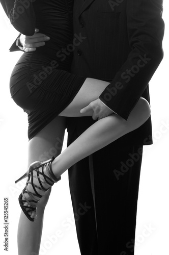 Принти на полотні Businessman holding long leg of his secretary isolated on white