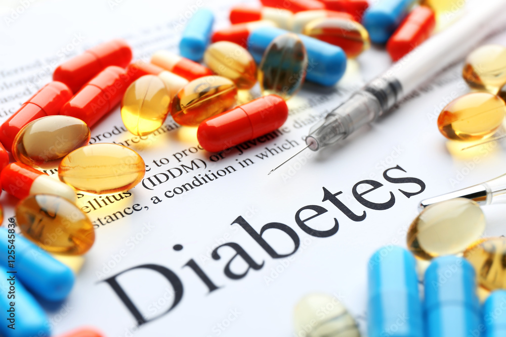 Pills and syringe on paper with text. Diabetes concept Pills and syringe on paper with text. Diabetes concept