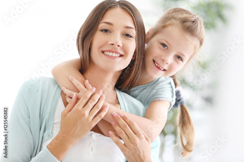 Cute girl with mother at home