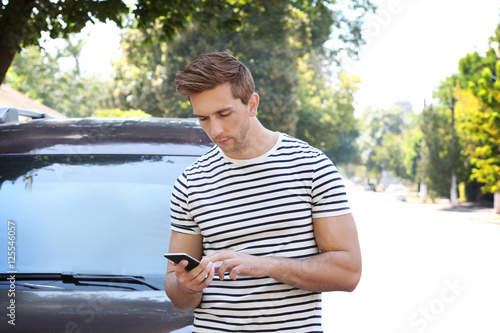 Young man with smart phone ...