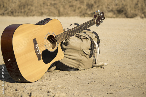 he guitar and backpack lying beside the road