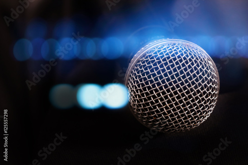 close up microphone with lights in background.
