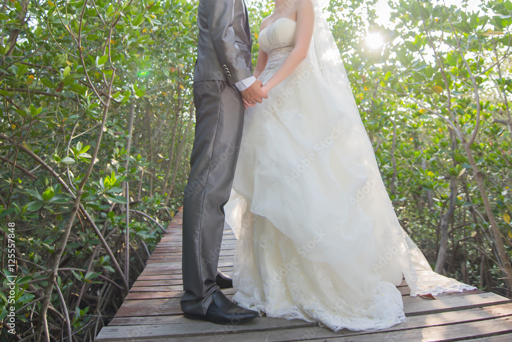 Happy and young pregnant couple hugging in nature. Happy and young pregnant couple hugging in nature.