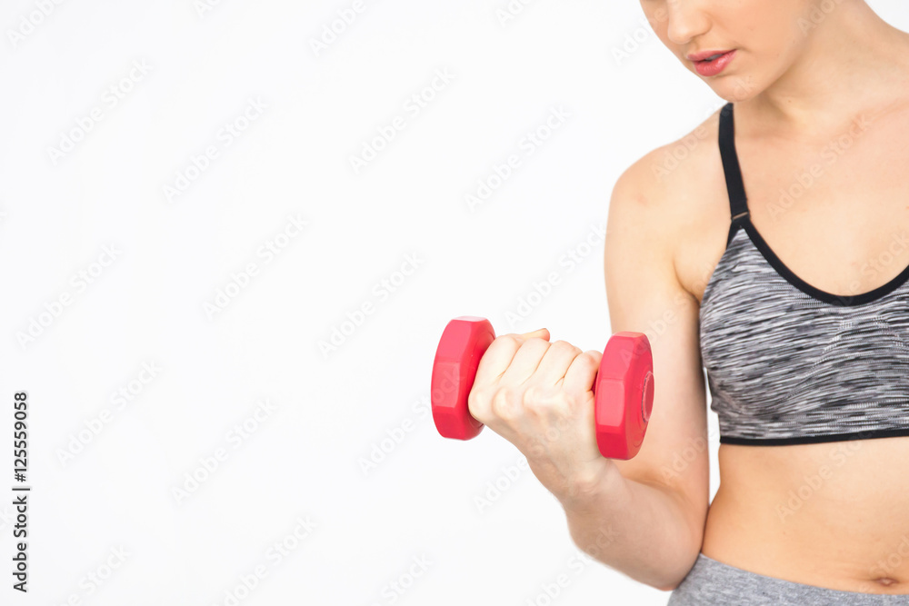 Closeup of Young woman lifting dumbbells with copy space over white background - Health and Fitness concept Closeup of Young woman lifting dumbbells with copy space over white background - Health and Fitness concept