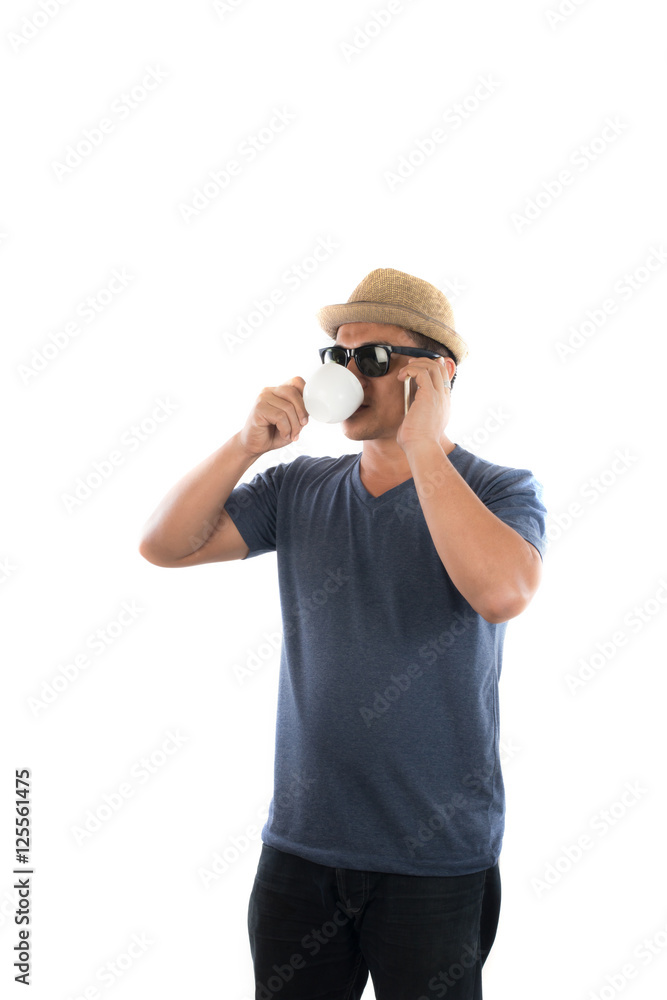 Handsome hipster young man in hat and sunglasses standing and ta Handsome hipster young man in hat and sunglasses standing and ta