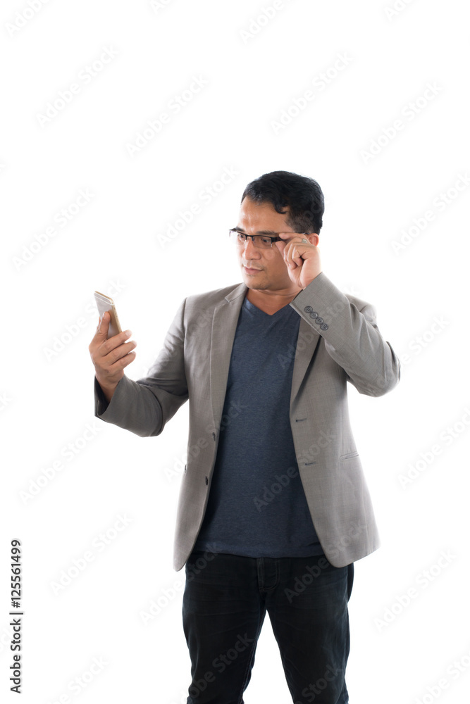 Handsome businessman and glasses standing and looking on mobile Handsome businessman and glasses standing and looking on mobile