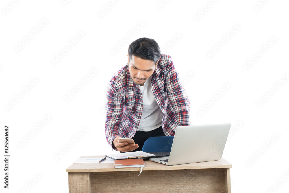 Young businessman looking at business chart in hand sitting at h Young businessman looking at business chart in hand sitting at h