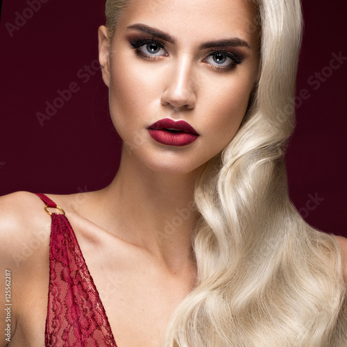 Fotografie Beautiful blonde in a Hollywood manner with curls, red lips, red lingerie