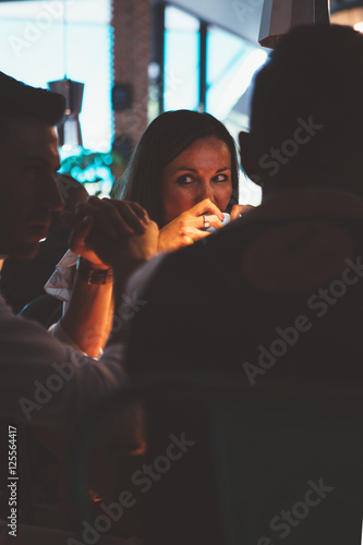 Brunette woman drinking coffee with friends