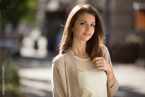 Outdoor portrait of beauty woman with perfect smile standing on the street